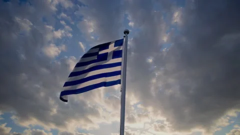 The glorious Greek flag waves majestically against a breathtakingly dramatic sky Stock Footage 306178566