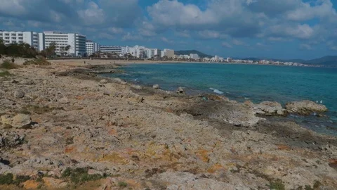A glorious view of Calla Millor beach, A patch of white clouds on blue sky Stock Footage 118294736