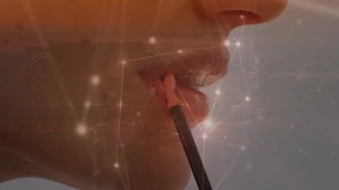 Gloss applicator pressing lower lip glowing node overlay depositing peach-toned Stock Footage 327124925
