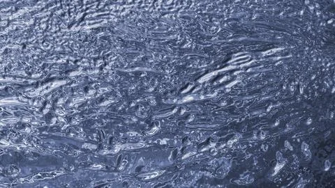 Glossy blue liquid surface with ripples and reflections Stock Illustration