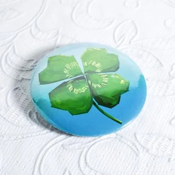 Glossy button pin with clover design Stock Photos
