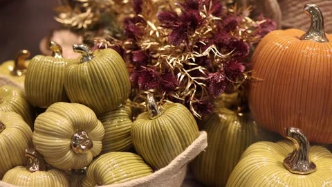 Glossy ceramic pumpkins and dried flowers in autumn decor Video stock 347812901