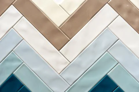 Glossy ceramic tiles in the shape of a herringbone. Stock Photos