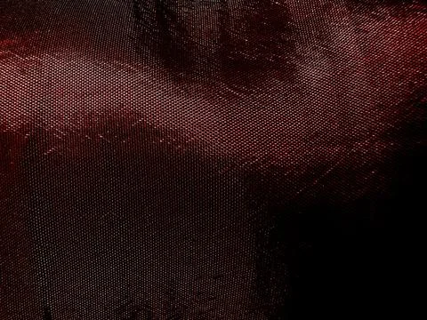 Glossy dark red wavy fabric texture abstract background undulating in mysterious Foto stock