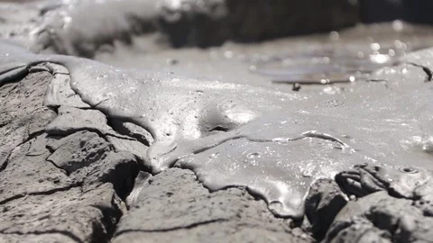 Glossy texture and rippled pattern of flowing liquid wet mud Stock Footage 339270053
