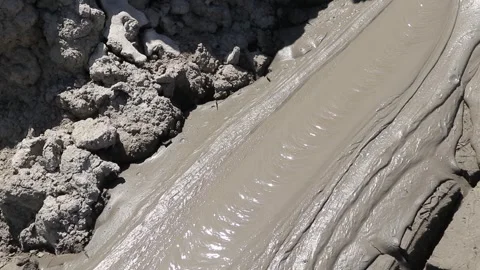 Glossy texture and rippled pattern of flowing liquid wet mud Stock Footage 339270068