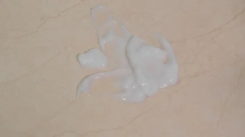 Glossy White Moisturizing Cream Spread on Warm Beige Surface in Abstract Mac Stock Footage 337425428