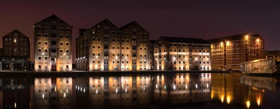 Gloucester Docks at night time with reflections of warehouse Stock Photos