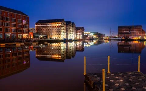 Gloucester docks on sharpness canal. Warehouse apartments reflected in quay w 写真素材