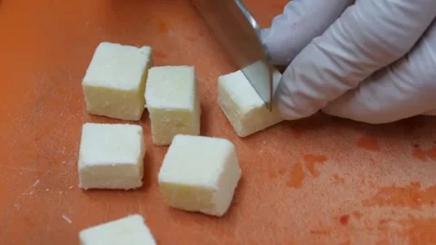 Gloved Chef Cutting Fresh Paneer Cheese Into Cubes on Orange Cutting Board 스톡 동영상 345653453