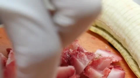 Gloved Chef Hands Slicing Fresh Strawberries and Bananas on Cutting Board 스톡 동영상 345652789