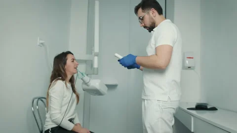 A gloved dentist makes an X-ray of the teeth in the dental office. Dental care Stock Footage 150950322
