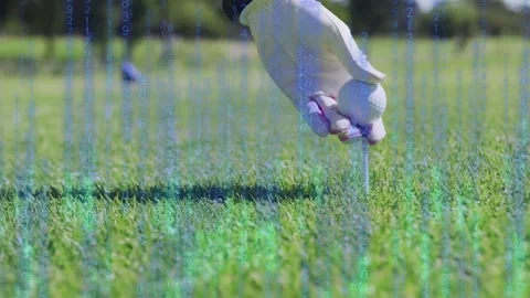 Gloved golfer's hand entering frame causing data overlay rising, placing ball on Stock Footage 335652043