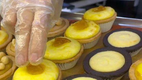 Gloved Hand Adding Cheese to Lemon Tart in Close-Up Vídeo Stock 279053772