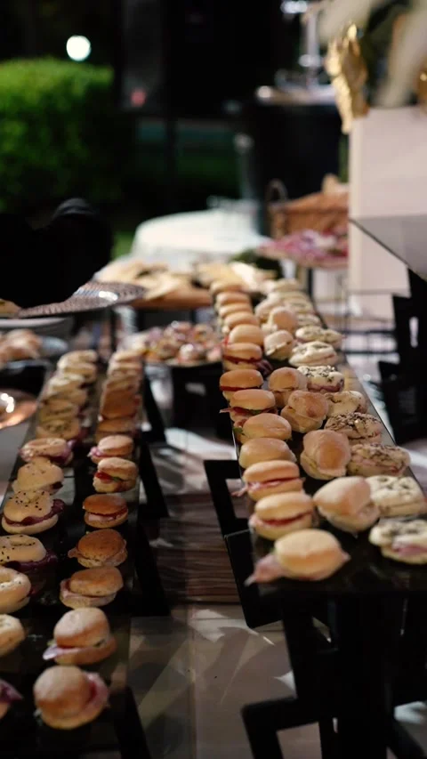 Gloved Hand Arranging Gourmet Appetizers on Catering Reception Table Stock Footage 336639575