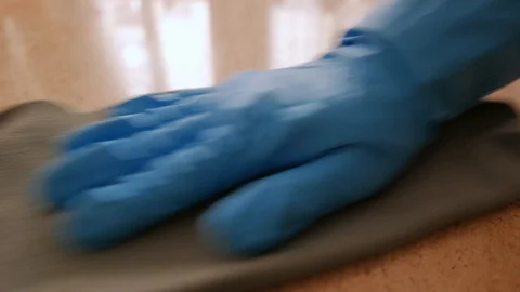 Gloved hand cleaning a marble surface Stock Footage 106659549