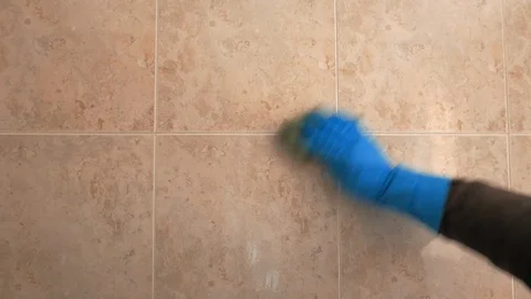 Gloved hand cleaning a wall Stock Footage 106659561