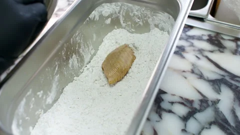 Gloved Hand Coating Raw Chicken Wings in Flour on Marble Kitchen Countertop Stock Footage 337987784