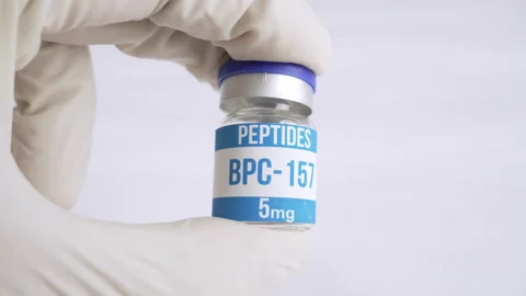 Gloved hand holding bpc-157 peptide vial Stock-Footage 345008613