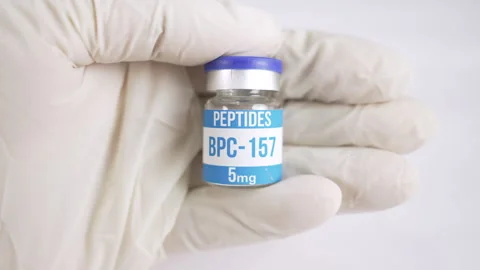 Gloved hand holding an BPC 157 peptide vial Stock Footage 345106901