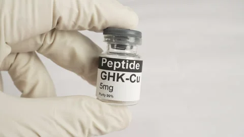Gloved hand holding ghk-cu copper peptide vial Stock Footage 343617058