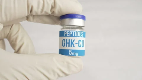 Gloved hand holding ghk-cu copper peptide vial Stock-Footage 344999900