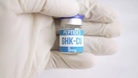 Gloved hand holding an GHK Cu peptide vial Video stock 345008634