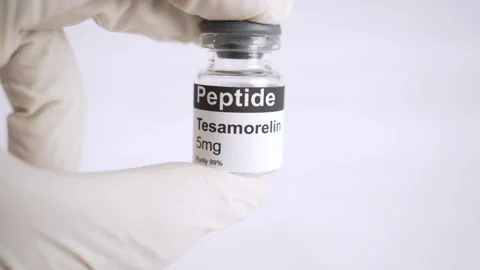 Gloved hand holding tesamorelin peptide vial Stock Footage 343617047