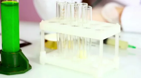 Gloved hand holding the test tubes in the laboratory. It is a chemical process 動画素材 63426322
