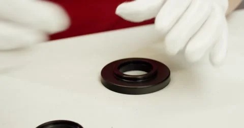 Gloved Hand Inspecting Black Radial Shaft Seal, White Table, Top Down Close Up Stock Footage 340691810