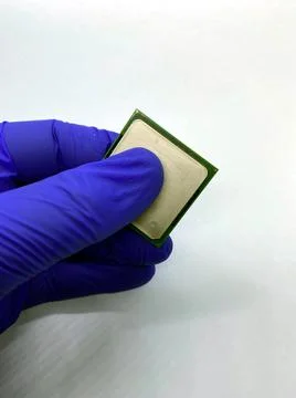 Gloved hand keeping a microprocessor closeup view with white background Stock Photos