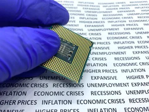 Gloved hand keeping a microprocessor with text containing recession, economic 스톡 사진
