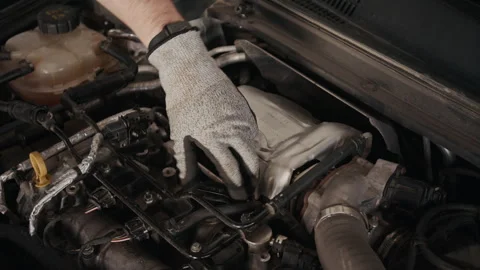 Gloved Hand of Mechanic Removing Cap from Oil Reservoir in Car Engine Stock Footage 329403715