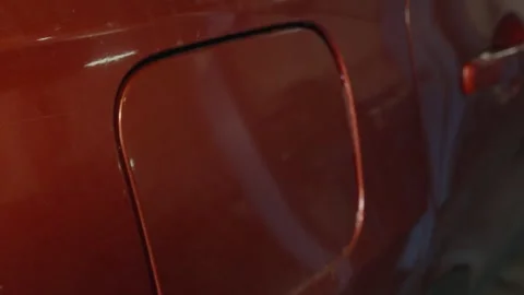 A gloved hand opens or closes the fuel cap of a car. Stock Footage 340558653