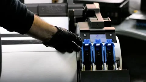 Gloved Hand Operating Industrial Printer in Workspace Setting 스톡 동영상 320991341