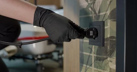Gloved Hand Plugging Steam Cleaner Power Cord Into Wall Socket Stock Footage 340274879