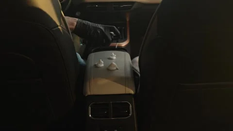 Gloved Hand Points At White Spill On Leather Armrest Inside Car Stock Footage 335214108