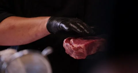 Gloved Hand Pressing Marbled Ribeye Steak, Dark Studio Surface, Macro Shot Stock Footage 340320140