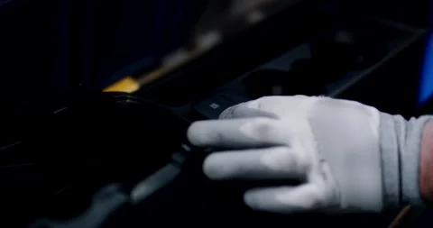 Gloved Hand Reaches for Part at Blue Lit Assembly Station Video stock 340215971
