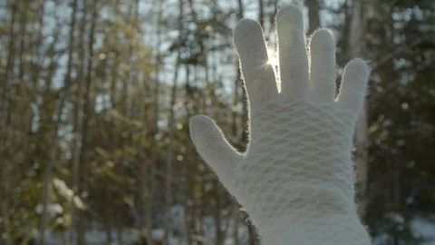 Gloved hand reaching for the sun in winter, concept 4k Stock Footage 120653869