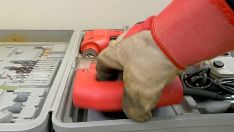 Gloved hand removing a jigsaw from a box of power tools. Stock Footage 154739620