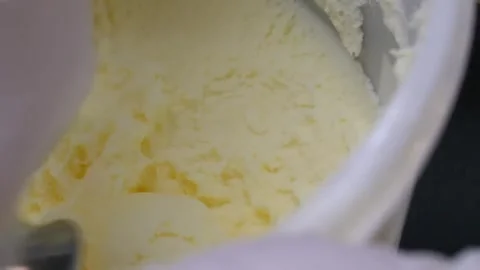 Gloved Hand Scooping Fresh Vanilla Ice Cream Close Up Video stock 345654461