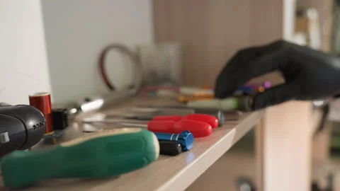 Gloved Hand Selecting Item from Neatly Arranged Lab Tools on Shelf Stock Footage 282299280