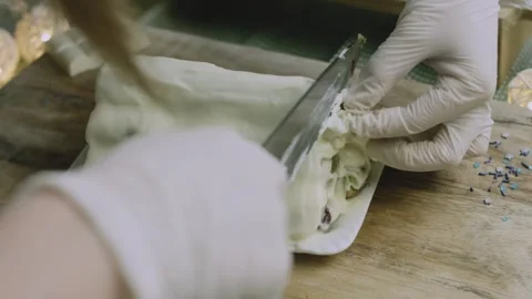 Gloved hand separating the first end slice Stock Footage 342129373
