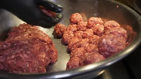 Gloved Hand Shaping Raw Meatballs in Metal Bowl Stock-Footage 347689211