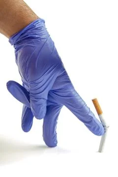 Gloved hand throwing cigarette Quit smoking metaphor Stock Photos