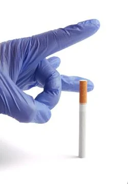 Gloved hand throwing cigarette Quit smoking metaphor Stock Photos