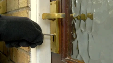 Gloved hand using a key to unlock and open an outside door. Video stock 170492054
