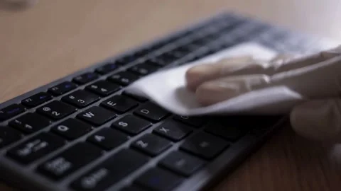 Gloved hand wiping computer keyboard with a wet cloth 動画素材 332282133