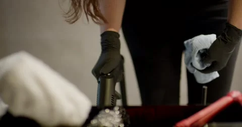 Gloved Hand Wiping Down a Dark Cleaning Machine With a White Cloth Video stock 340271357